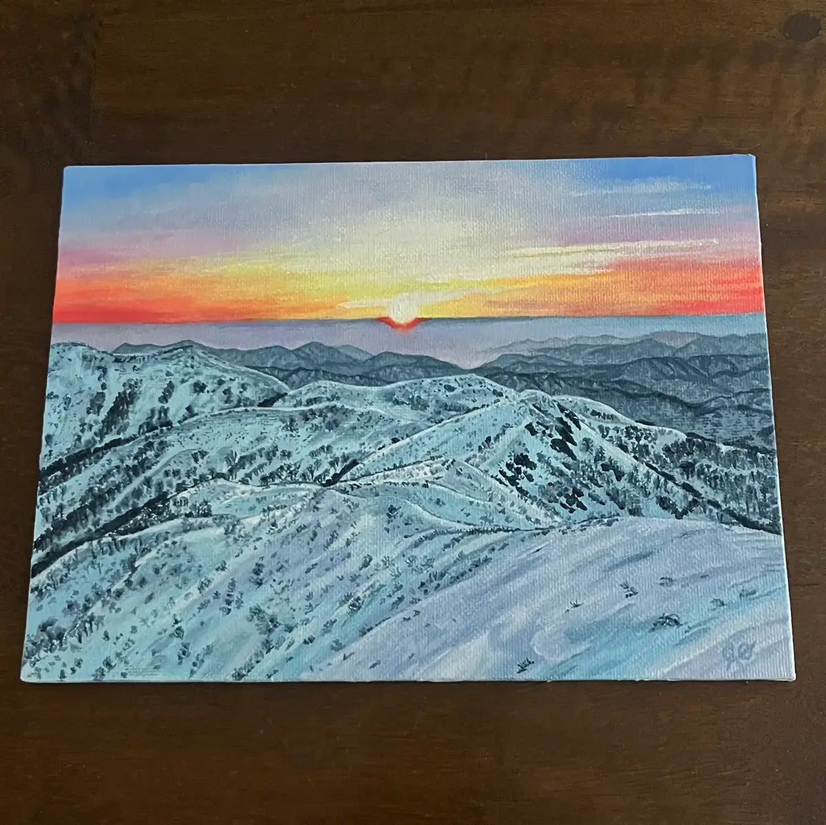 Painting on panel of a snowy mountain landscape sunset scene.